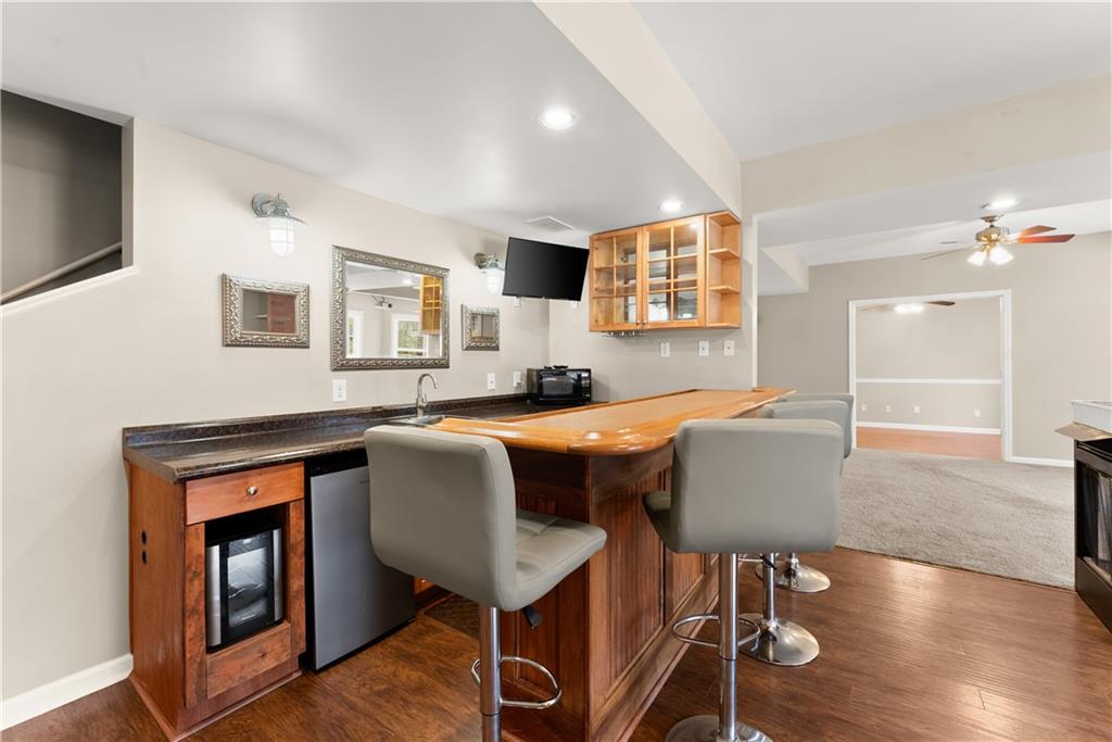1070 Coleridge Way Suwanee, GA 30024 - Photo 49 of 76 a living room with furniture wooden floor and a flat screen tv