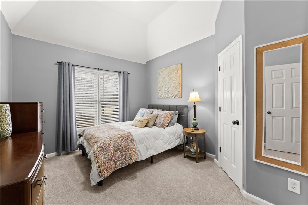 1070 Coleridge Way Suwanee, GA 30024 - Photo 50 of 98 a bedroom with a bed lamp and a window