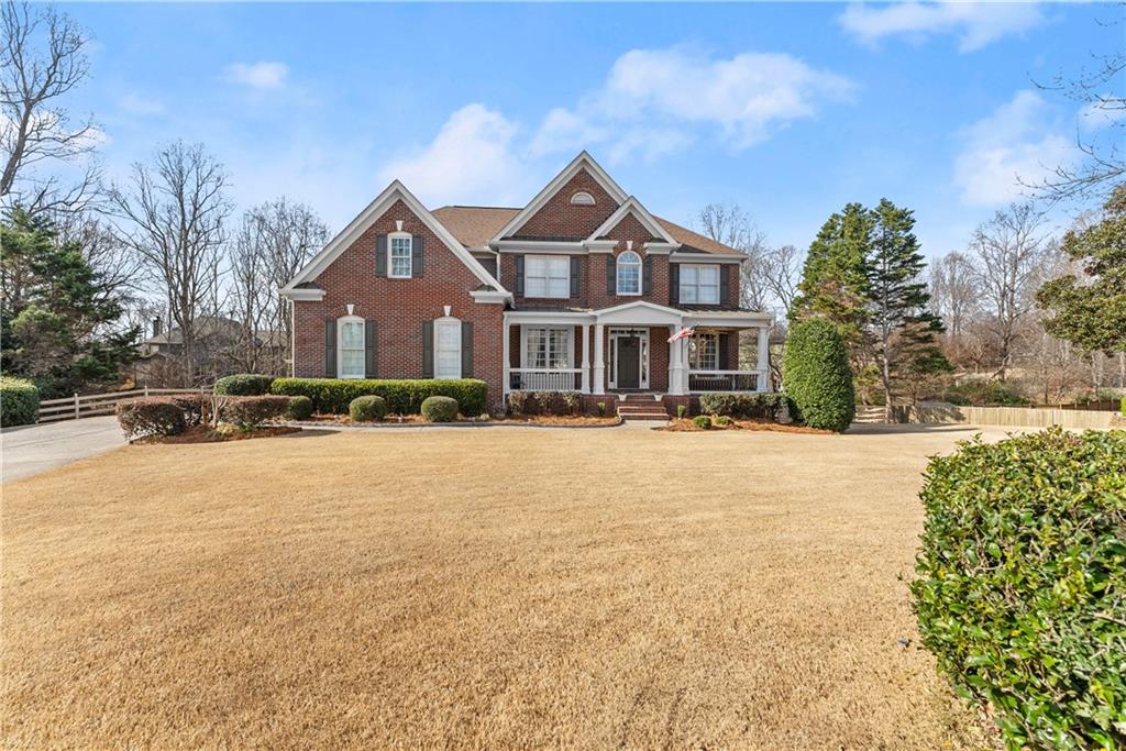 1070 Coleridge Way Suwanee, GA 30024 - Photo 5 of 98 a front view of a house with a yard