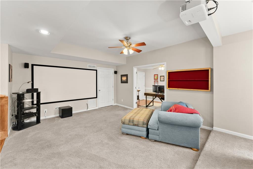 1070 Coleridge Way Suwanee, GA 30024 - Photo 59 of 98 a bedroom with furniture and a chandelier fan