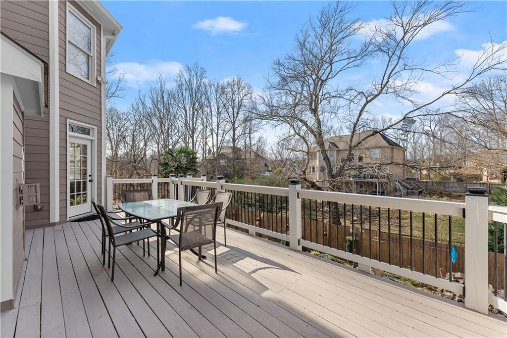 1070 Coleridge Way Suwanee, GA 30024 - Photo 61 of 76 a balcony with wooden floor table and chairs