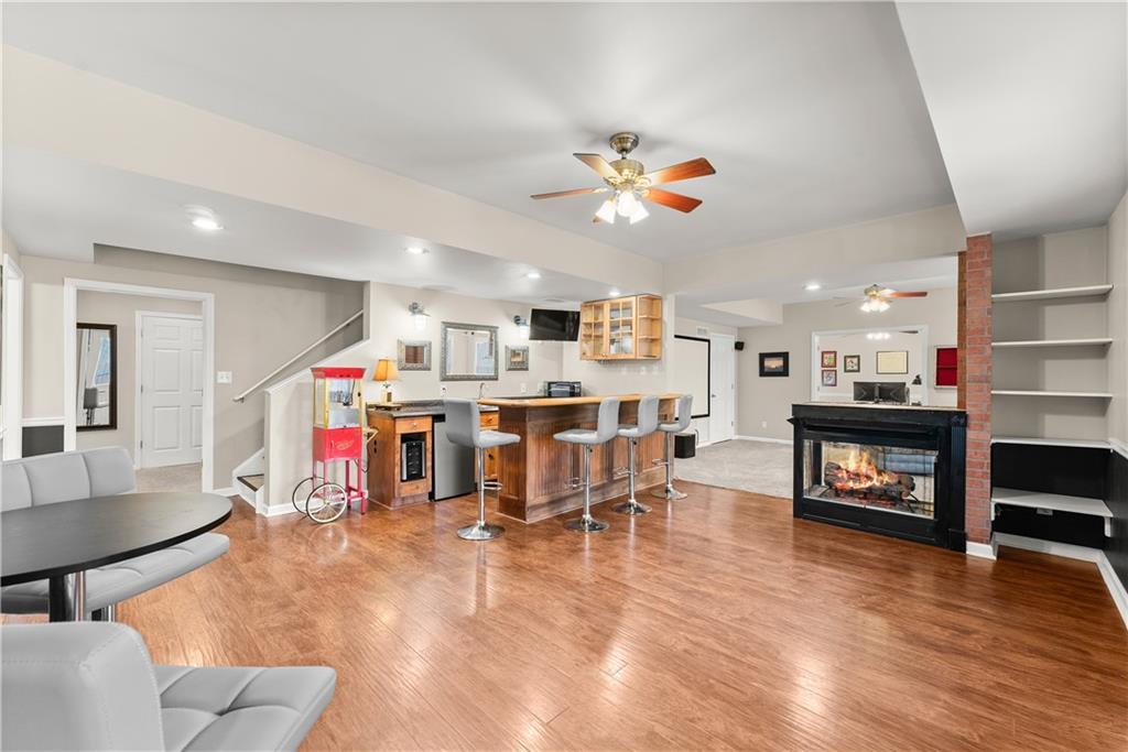 1070 Coleridge Way Suwanee, GA 30024 - Photo 62 of 98 a living room filled with furniture and a wooden floor