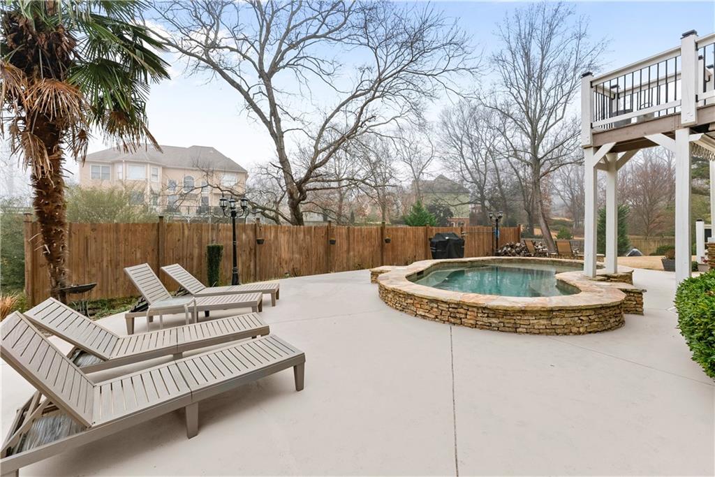 1070 Coleridge Way Suwanee, GA 30024 - Photo 71 of 98 a view of a house with swimming pool and sitting area