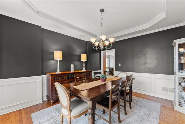 a open kitchen with stainless steel appliances granite countertop a stove a sink dishwasher and a refrigerator with wooden floor