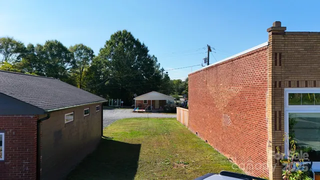 a view of a backyard with sitting area