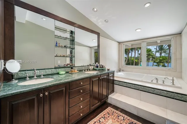 a spacious bathroom with a granite countertop sink and a large mirror
