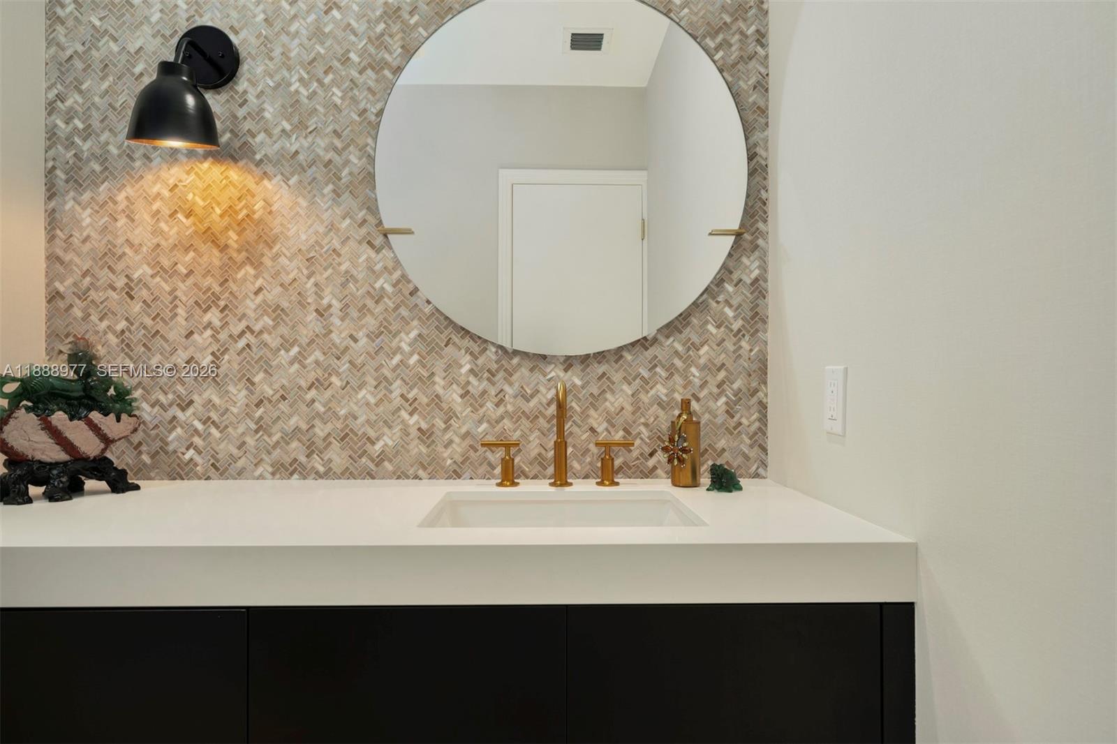 8845 School House Road Coral Gables, FL 33156 - Photo 19 of 23 a bathroom with a sink and a mirror