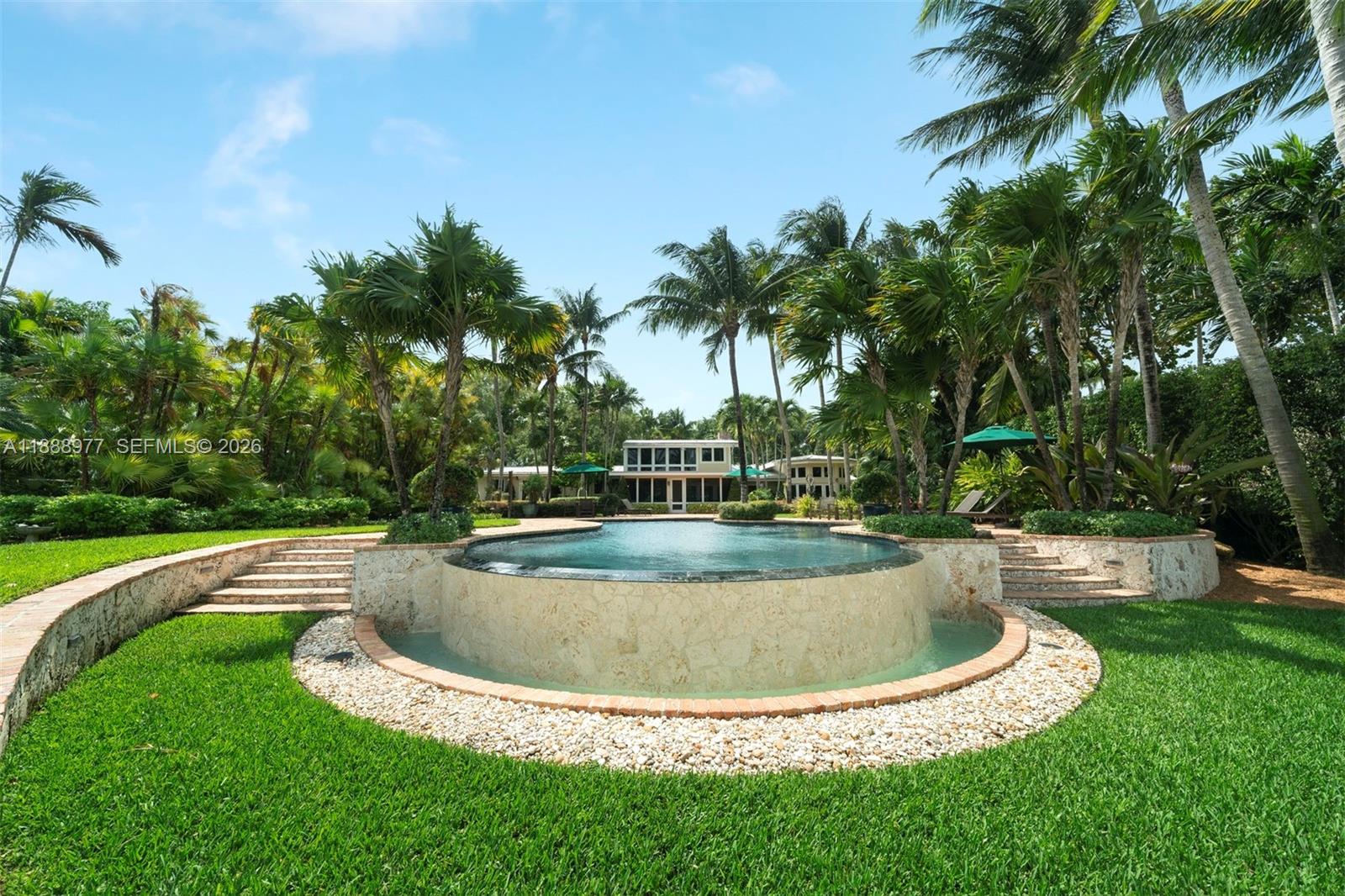 8845 School House Road Coral Gables, FL 33156 - Photo 20 of 23 a view of a swimming pool with a garden