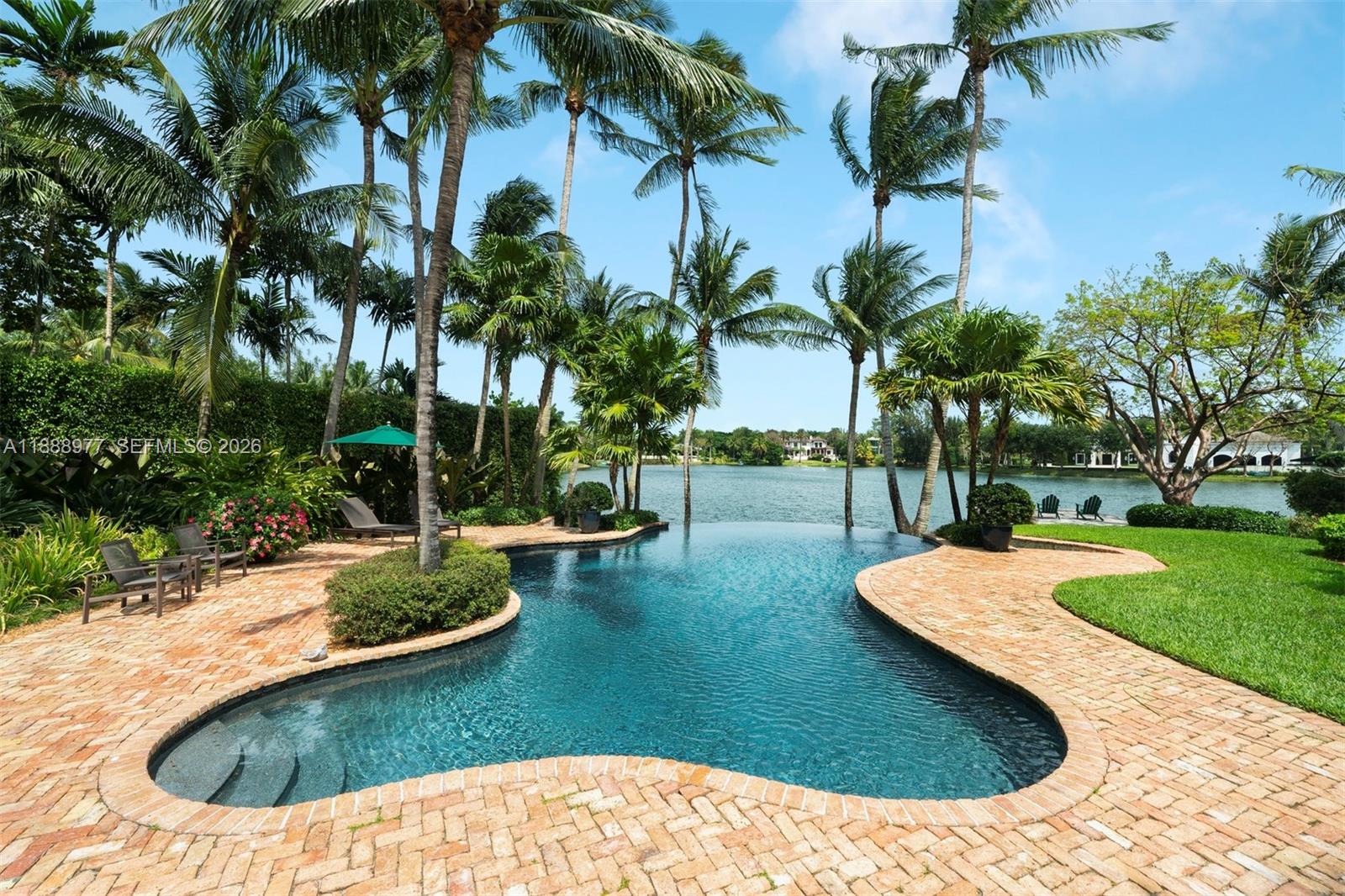 8845 School House Road Coral Gables, FL 33156 - Photo 8 of 23 a view of a swimming pool with a sitting area