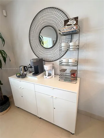 a view of a livingroom with wooden floor and a bathroom space