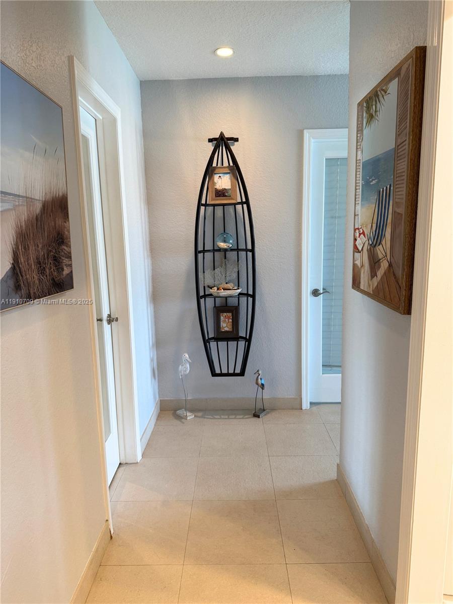 1705 North Riverside Drive, Unit 1 Pompano Beach, FL 33062 - Photo 13 of 36 a view of a livingroom with wooden floor and a bathroom space