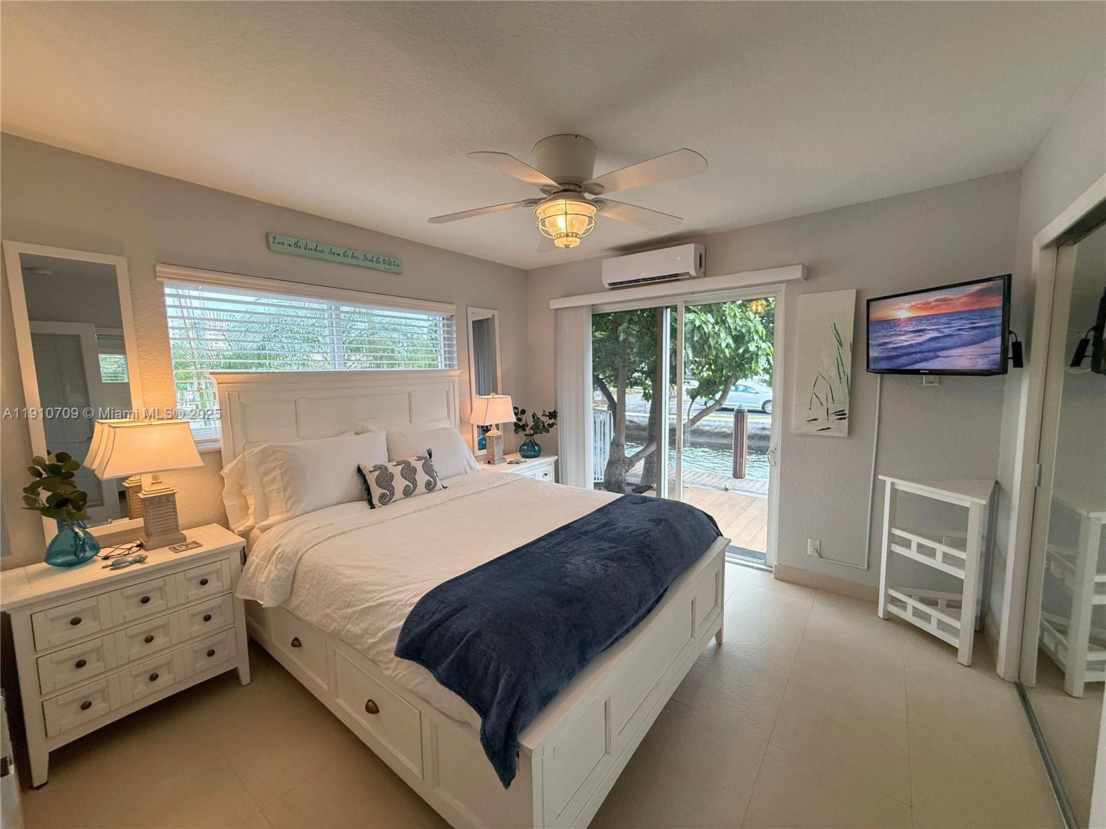 1705 North Riverside Drive, Unit 1 Pompano Beach, FL 33062 - Photo 19 of 36 a bedroom with a bed dresser and a window