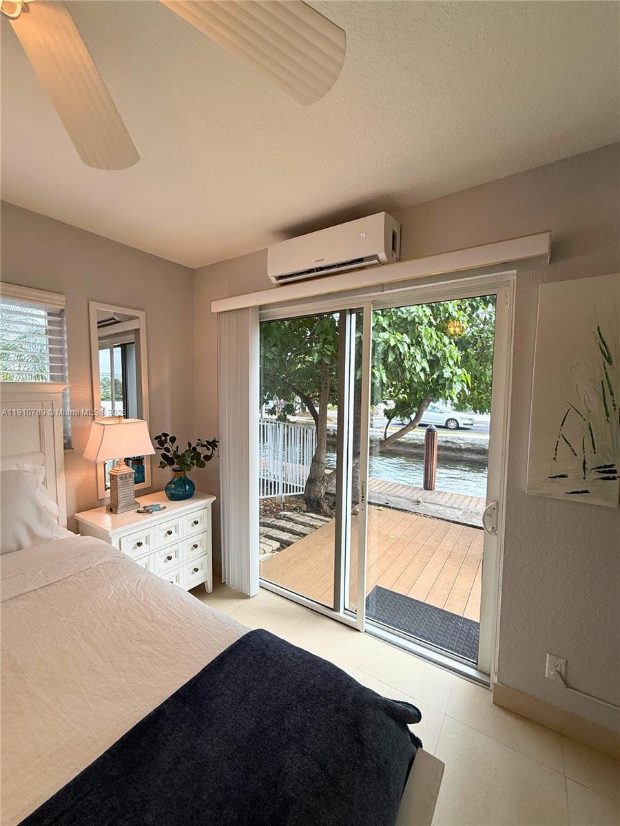 1705 North Riverside Drive, Unit 1 Pompano Beach, FL 33062 - Photo 20 of 36 a bedroom with furniture and large windows