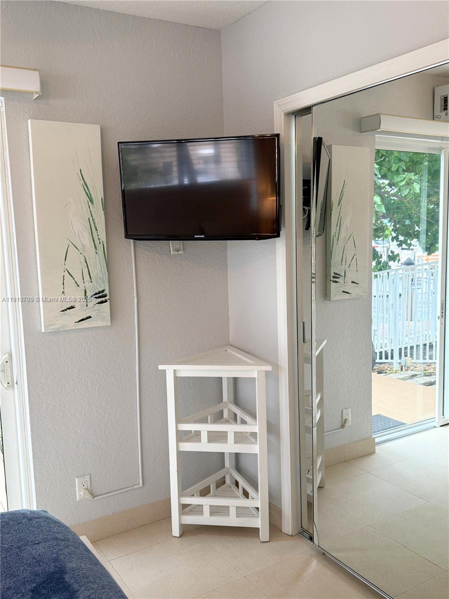 1705 North Riverside Drive, Unit 1 Pompano Beach, FL 33062 - Photo 22 of 36 a en suite bathroom with a glass shower door and a bathtub