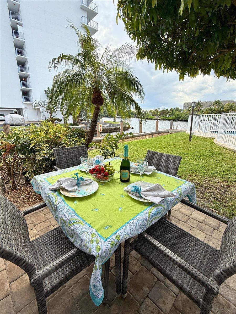1705 North Riverside Drive, Unit 1 Pompano Beach, FL 33062 - Photo 5 of 36 a view of a patio with table and chairs and potted plants
