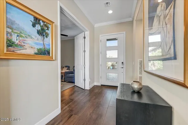 a dining hall with stainless steel appliances kitchen island granite countertop a dining table chairs and granite counter tops