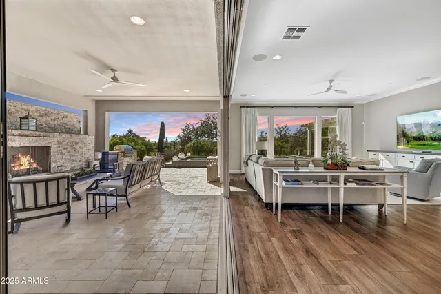 a kitchen with stainless steel appliances kitchen island granite countertop a dining table chairs and granite counter tops