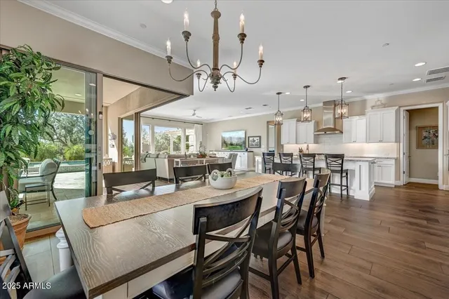 a large kitchen with granite countertop a stove top oven a sink a counter space and stainless steel appliances