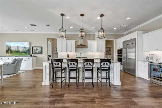 a living room with furniture a large window and wooden floor