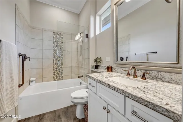 a bathroom with a granite countertop tub sink and mirror