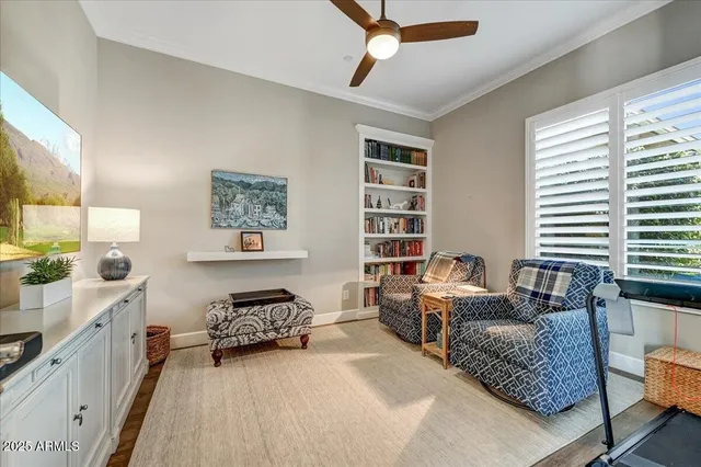 a view of a patio with couches and table and chairs with wooden floor and fence