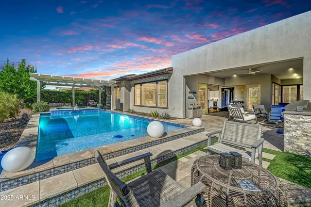 a living room with lots of furniture and a floor to ceiling window