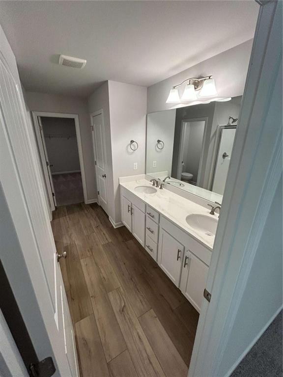 37 Mountain Chase Road Southwest Rome, GA 30165 - Photo 18 of 24 a bathroom with a sink a toilet a mirror and vanity