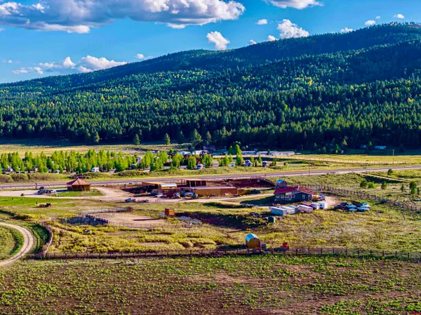 a view of a swimming pool with a table and chairs under an umbrella