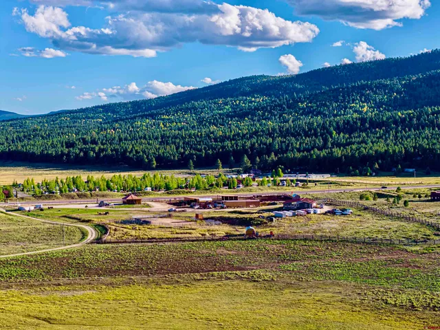a view of a house with backyard porch and sitting area