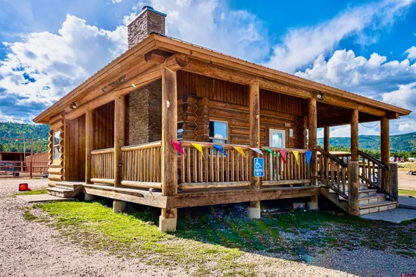 a view of a house with wooden fence