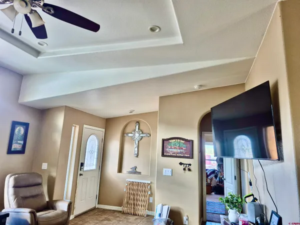 a bedroom with bed and a chandelier