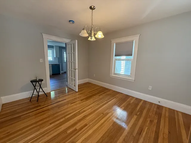 a view of a room with wooden floor lounge chair and windows