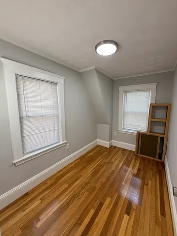 a view of a room with wooden floor and electronic appliances