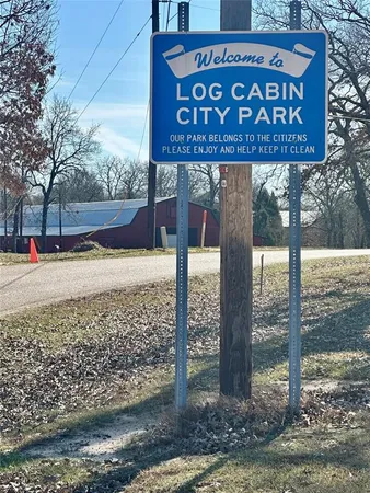 a view of a street sign under a large tree