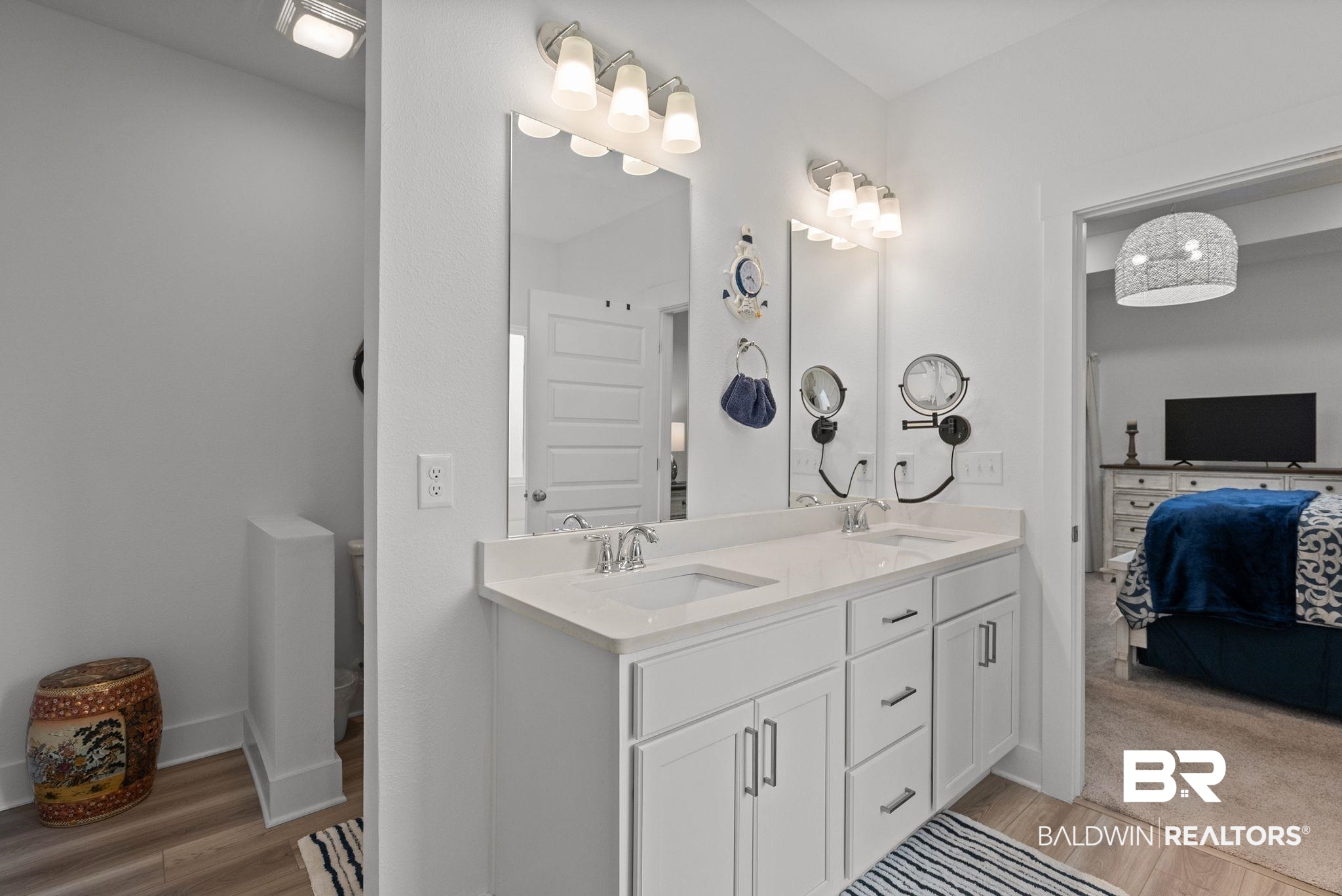 9899 Willet Way Foley, AL 36535 - Photo 20 of 37 Dual vanity with white cabinetry and chrome hardware, featuring two undermount sinks and a light-toned countertop