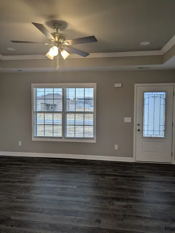 a view of wooden floor and a chandelier fan in a room