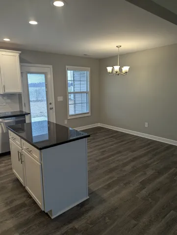 a kitchen with granite countertop a sink and a stove