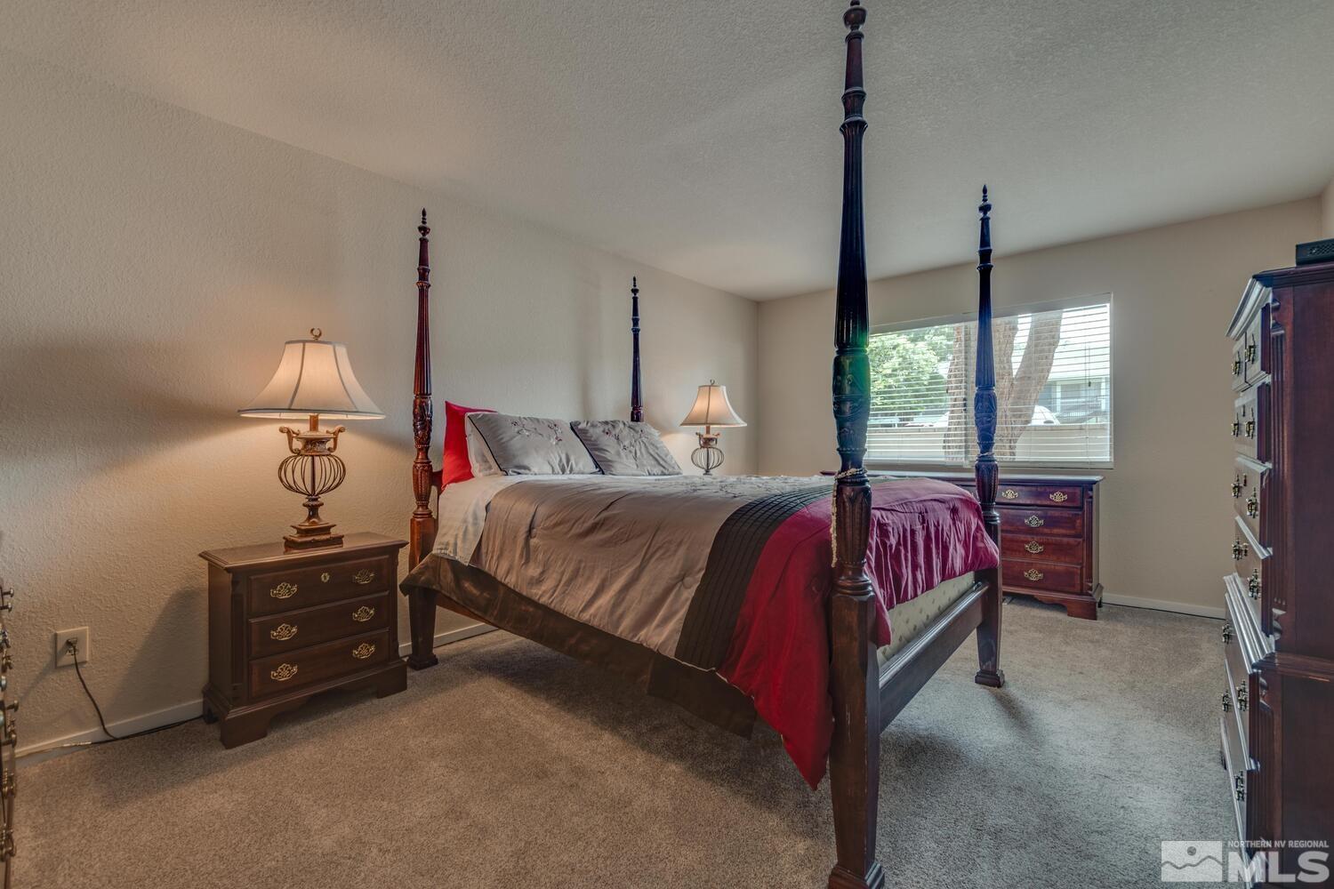 2300 Dickerson Road, Unit 73 Reno, NV 89503 - Photo 12 of 25 a bedroom with a bed and large window