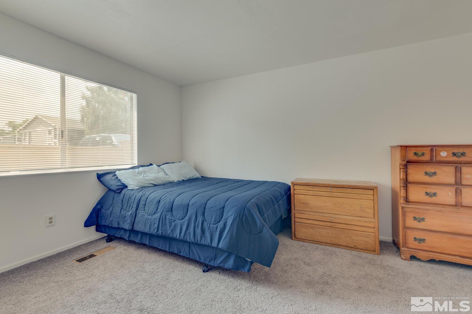2300 Dickerson Road, Unit 73 Reno, NV 89503 - Photo 15 of 25 a bedroom with a bed and a dresser