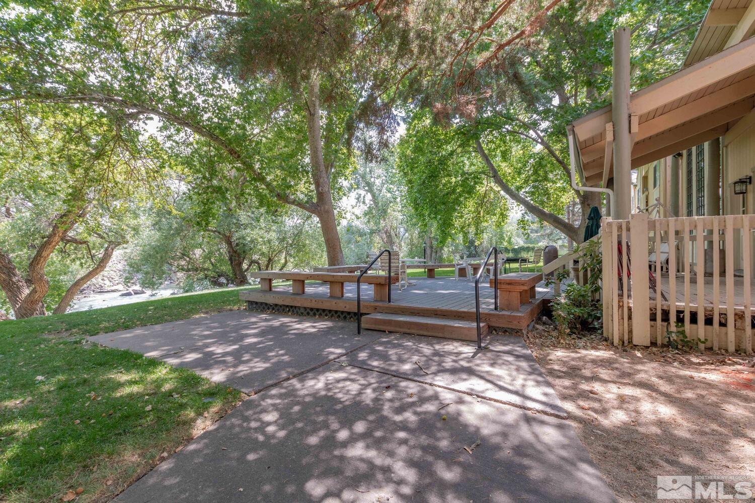 2300 Dickerson Road, Unit 73 Reno, NV 89503 - Photo 19 of 25 a view of a backyard with wooden fence and a large tree