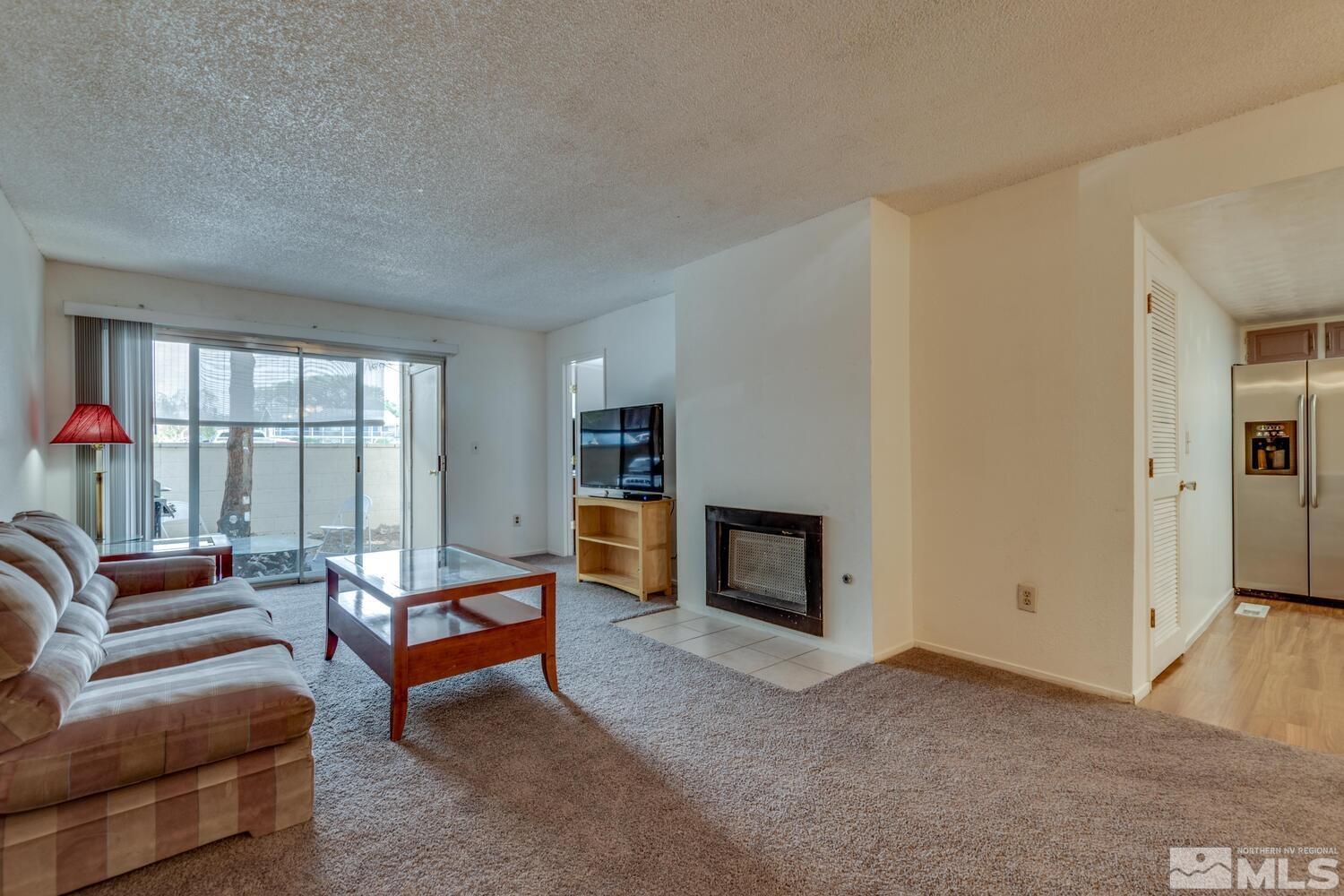 2300 Dickerson Road, Unit 73 Reno, NV 89503 - Photo 2 of 25 a living room with furniture and a fireplace