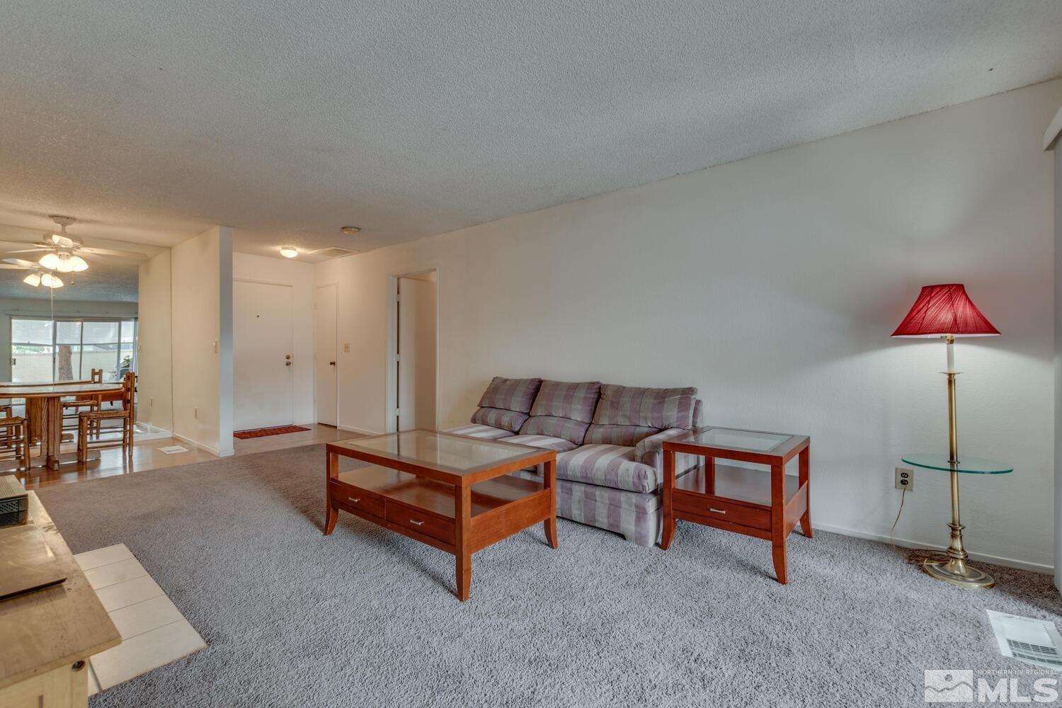 2300 Dickerson Road, Unit 73 Reno, NV 89503 - Photo 4 of 25 a living room with furniture a rug and white walls