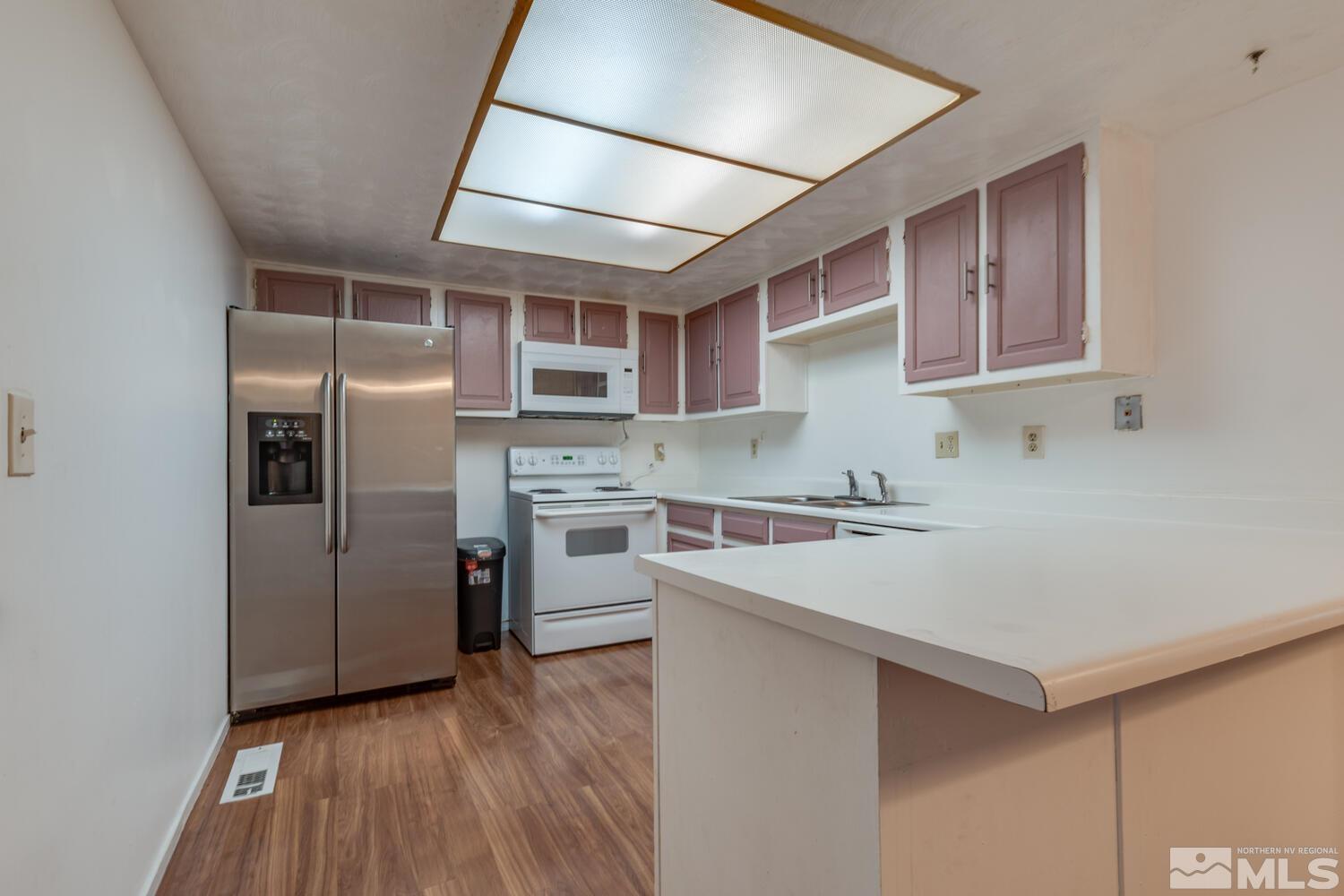 2300 Dickerson Road, Unit 73 Reno, NV 89503 - Photo 6 of 25 a kitchen with a refrigerator sink and cabinets