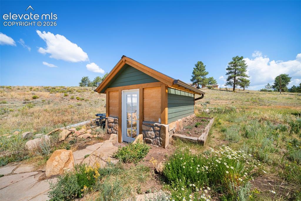 351 High Pasture Road Florissant, CO 80816 - Photo 29 of 39 Custom-built greenhouse with attractive stone accents.