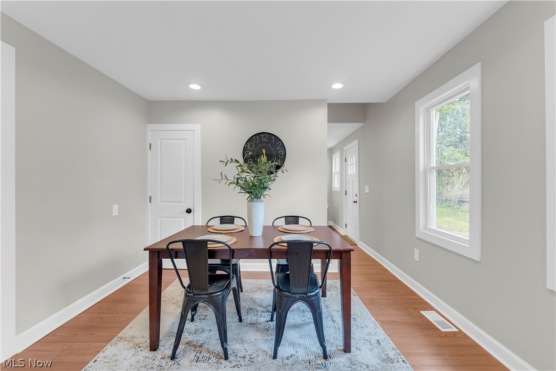 18155 Libby Road Maple Heights, OH 44137 - Photo 14 of 32 Spacious dining area featuring neutral wall tones, recessed lighting, wood-finish flooring, and a large window
