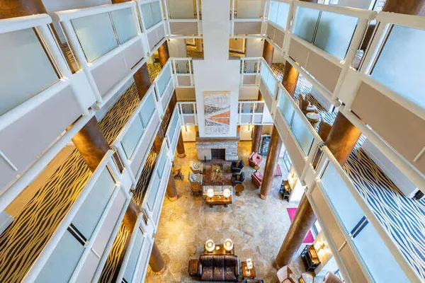 a bedroom with a bed and a large mirror on the dresser