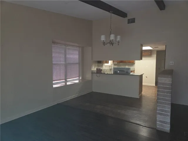 a living room with stainless steel appliances kitchen island granite countertop furniture and a fireplace