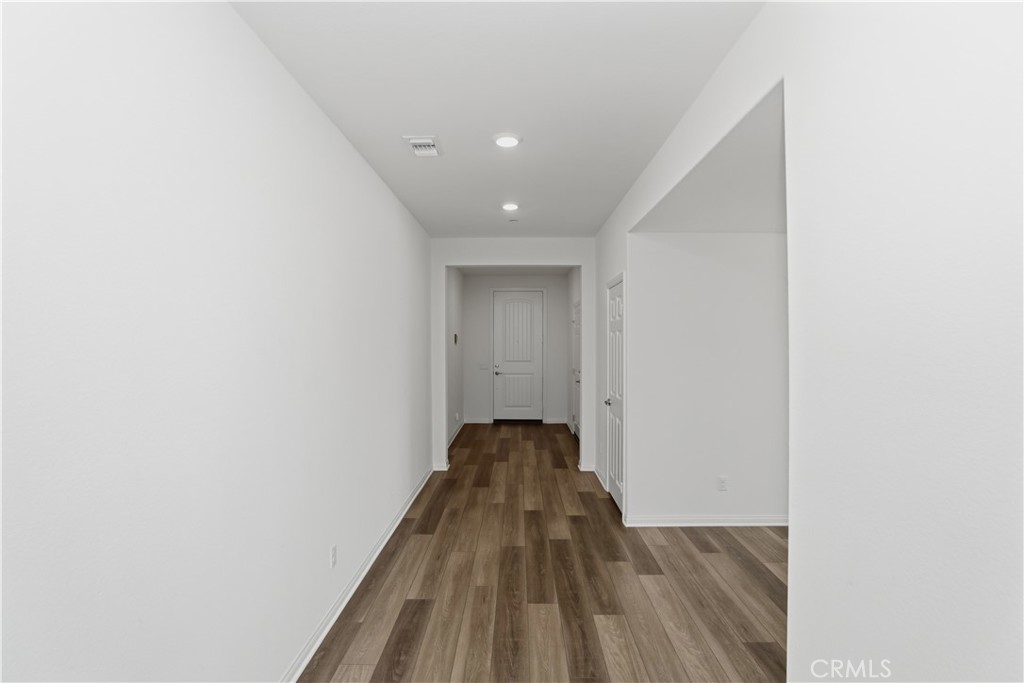 21159 Blue Jeans Court Riverside, CA 92507 - Photo 21 of 63 a view of a hallway with wooden floor and a bathroom