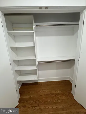 a view of walk in closet with empty racks