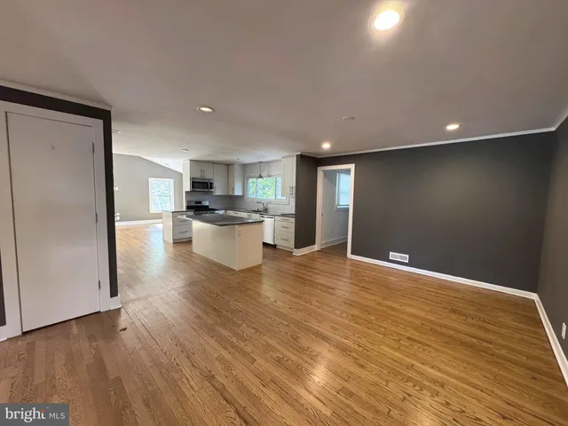 a view of a kitchen with a sink and a refrigerator